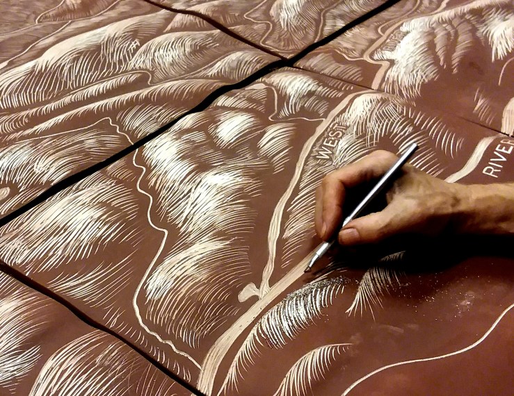Hand carving a landscape.